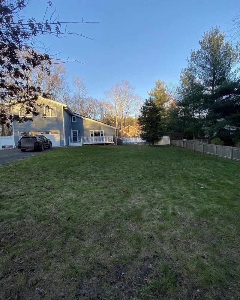 The same lawn cleared of leaves after the fall cleanup