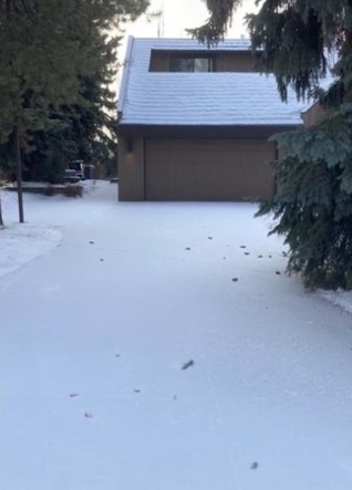 Driveway covered in snow, before snow removal